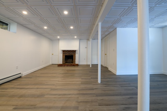 finished below grade area with baseboards, an ornate ceiling, recessed lighting, a fireplace, and wood finished floors