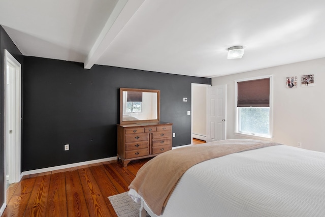 bedroom featuring wood finished floors, baseboard heating, beamed ceiling, and baseboards