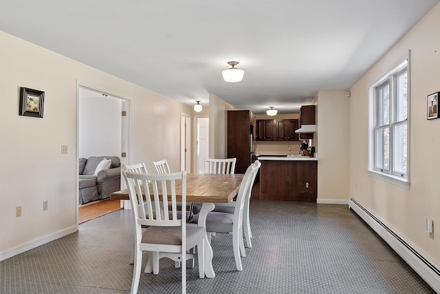 dining room featuring baseboard heating and baseboards