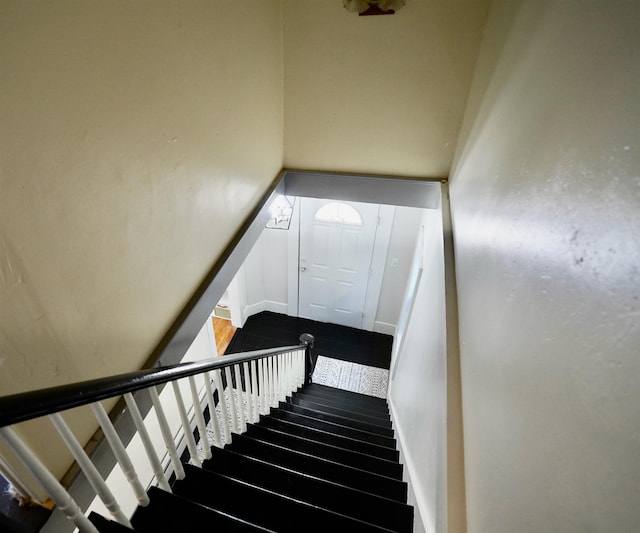 stairs featuring wood finished floors