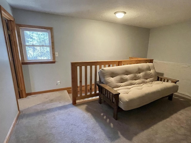 carpeted bedroom with baseboards and a textured ceiling