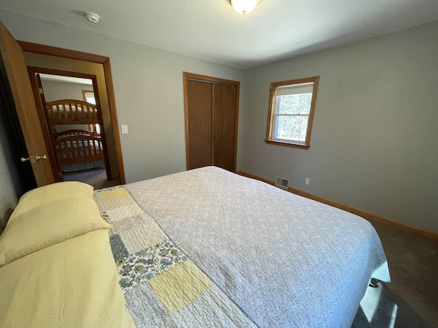 bedroom with a closet, baseboards, and visible vents