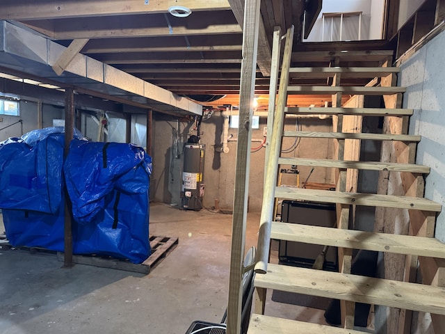 unfinished basement featuring water heater