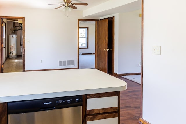 kitchen featuring visible vents, baseboards, a ceiling fan, water heater, and dishwasher