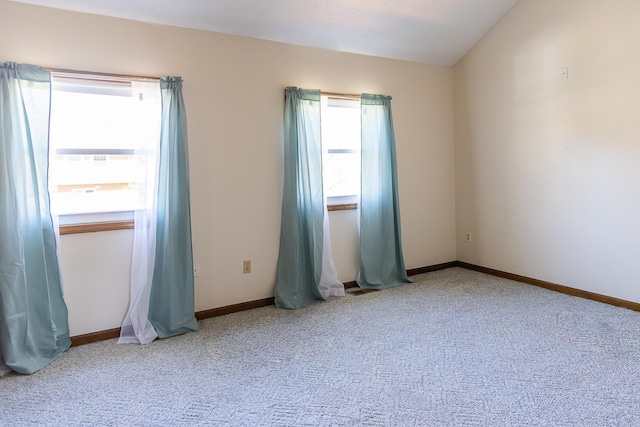 carpeted empty room featuring baseboards and visible vents