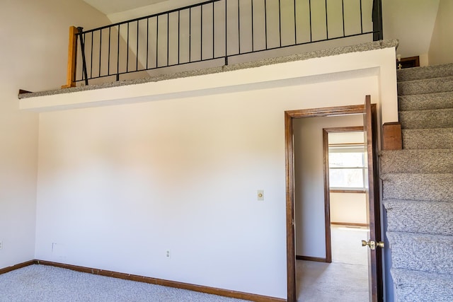 stairway with carpet floors and baseboards