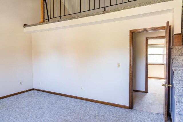 empty room featuring baseboards and carpet