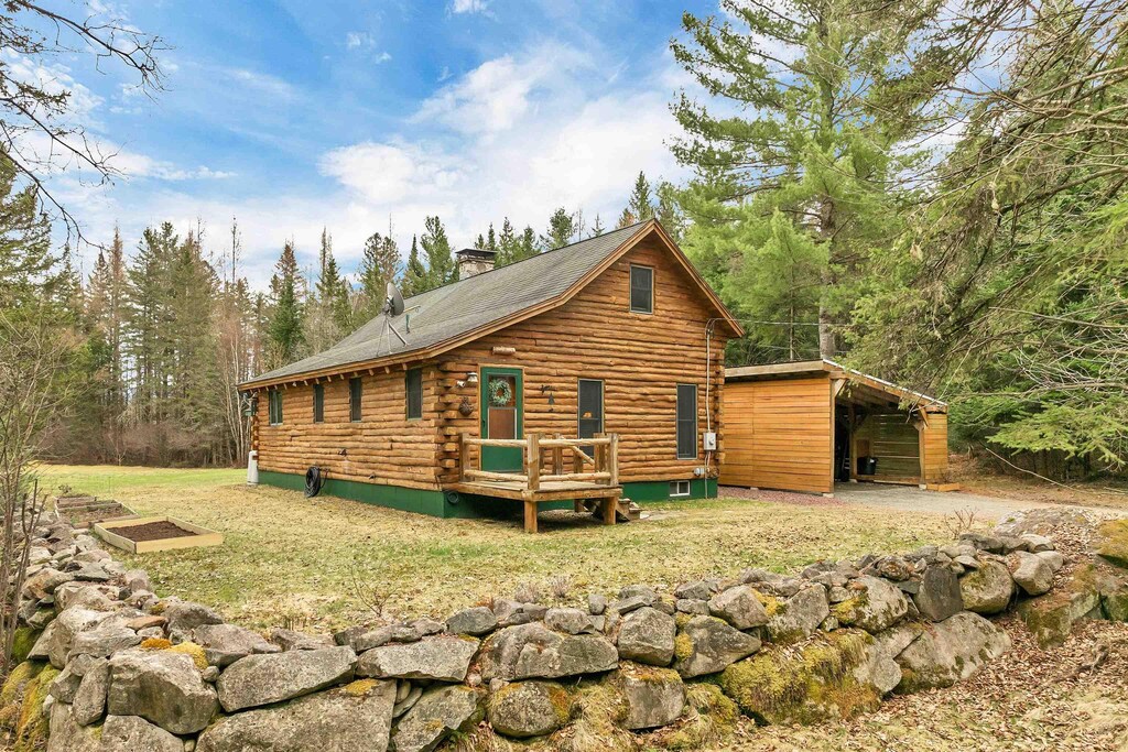 10 Longview Dr, Lancaster, NH 03584 - rear view of property with a lawn, log siding, a chimney, and a carport