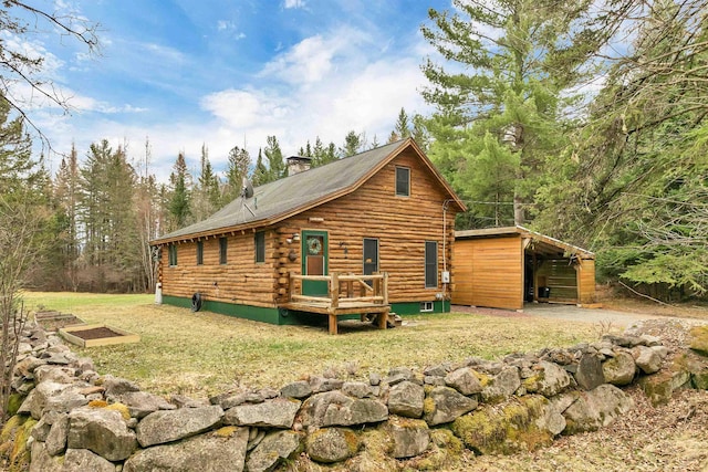 10 Longview Dr, Lancaster, NH 03584 - rear view of property with a lawn, log siding, a chimney, and a carport