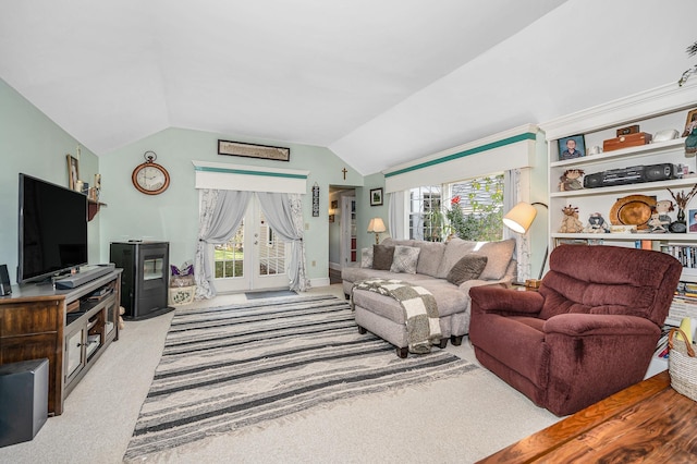 living room featuring french doors, vaulted ceiling, and light colored carpet