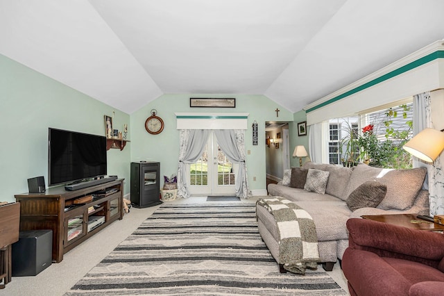 living room featuring vaulted ceiling, plenty of natural light, french doors, and carpet