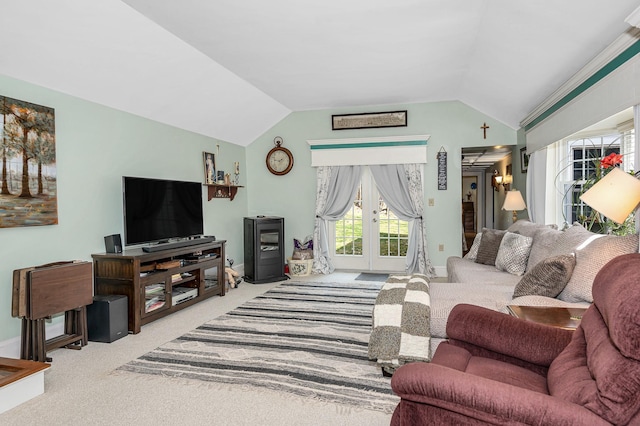 living area with carpet floors, baseboards, french doors, and lofted ceiling
