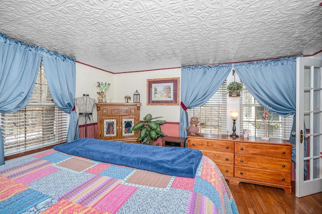 bedroom with an ornate ceiling and wood finished floors
