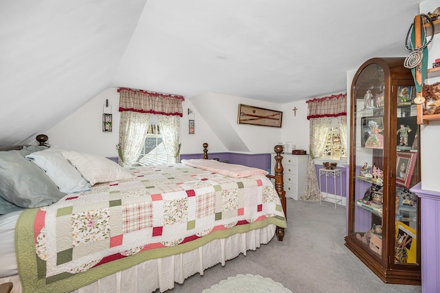 bedroom featuring carpet floors and vaulted ceiling
