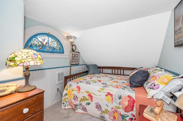 carpeted bedroom featuring vaulted ceiling and visible vents
