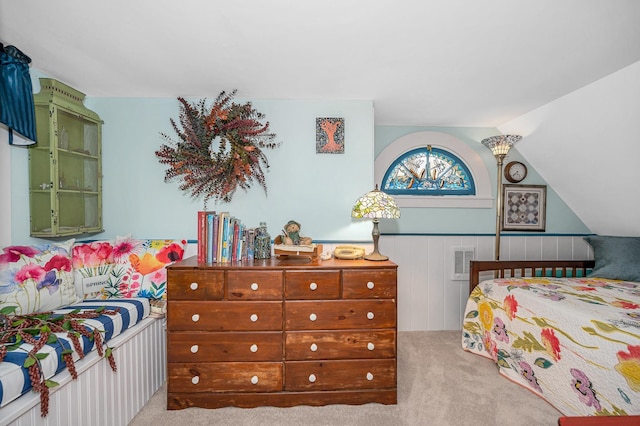 bedroom featuring carpet floors, wainscoting, and visible vents