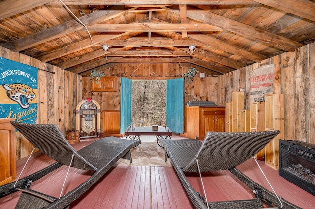 interior space featuring hardwood / wood-style floors, wooden walls, vaulted ceiling, and wooden ceiling