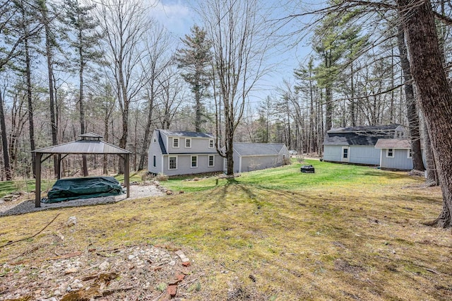 view of yard with a gazebo and an outbuilding