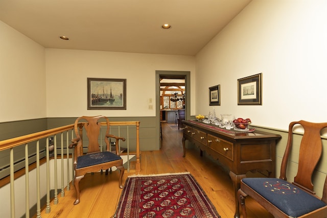 sitting room featuring wainscoting, recessed lighting, and hardwood / wood-style floors
