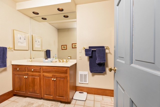 bathroom featuring visible vents, baseboards, tile patterned flooring, and vanity