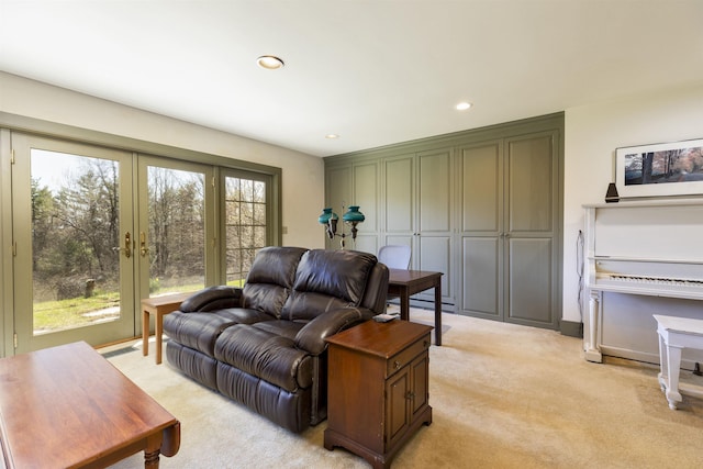 living room with light colored carpet, recessed lighting, baseboard heating, and french doors