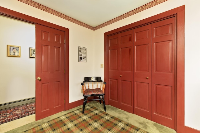 foyer featuring carpet floors and a baseboard heating unit