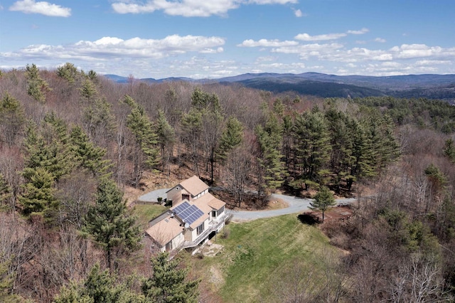 drone / aerial view with a view of trees and a mountain view