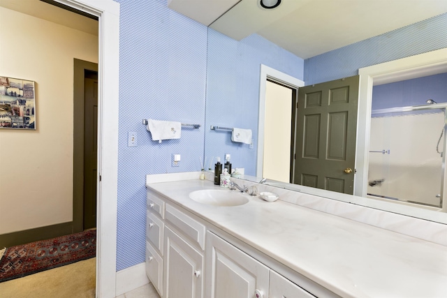 bathroom with an enclosed shower and vanity