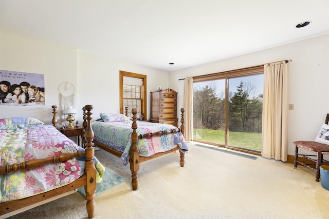 bedroom with access to outside and light carpet