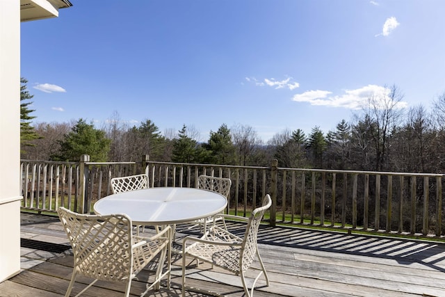 wooden terrace featuring outdoor dining space