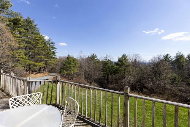 view of wooden balcony with outdoor dining space and a deck