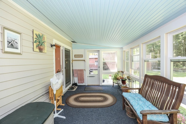 sunroom with carpet flooring, wood walls, and wood ceiling