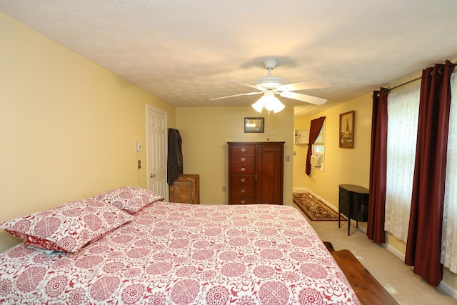 carpeted bedroom with baseboards and ceiling fan