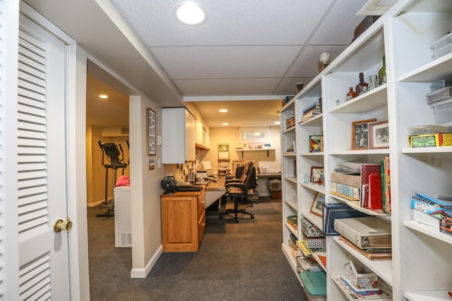 home office featuring dark carpet, recessed lighting, baseboards, and a drop ceiling