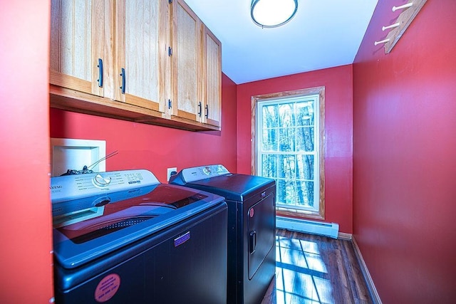 clothes washing area with cabinet space, dark wood-style flooring, baseboard heating, baseboards, and washing machine and dryer