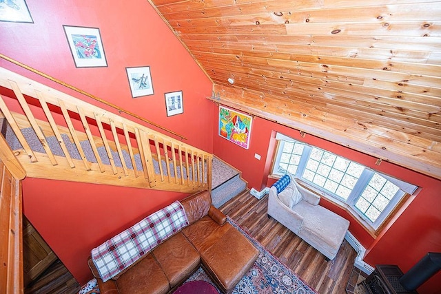 living area featuring baseboards, wood finished floors, vaulted ceiling, and wooden ceiling