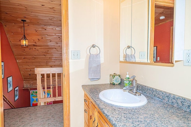 bathroom featuring wooden ceiling and vanity
