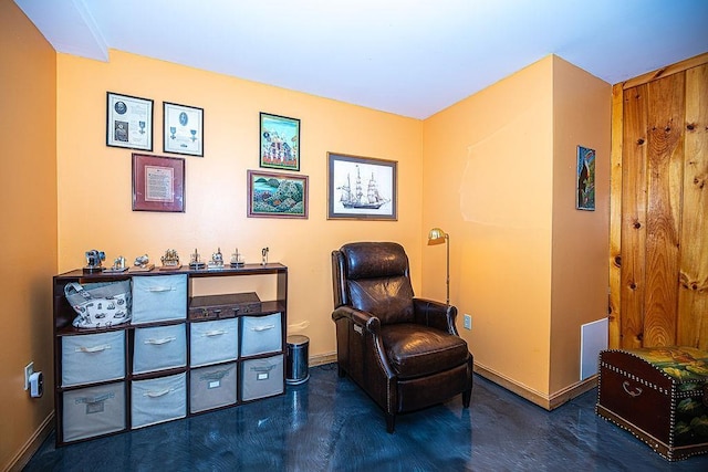living area featuring baseboards