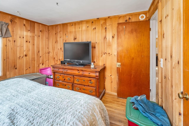 bedroom with wooden walls and wood finished floors