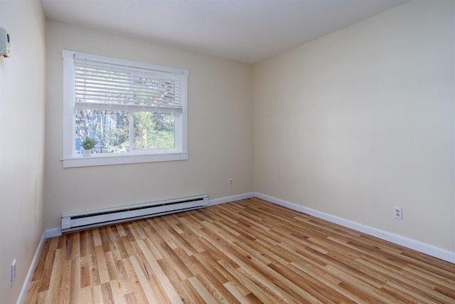 empty room with baseboards, a baseboard radiator, and light wood-type flooring
