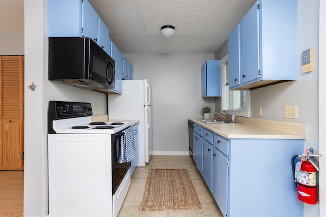 kitchen with a sink, light countertops, blue cabinetry, and white appliances