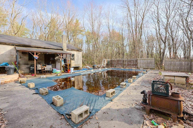 view of swimming pool with a fenced in pool, fence, and a patio