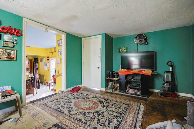 living room with baseboards and a textured ceiling