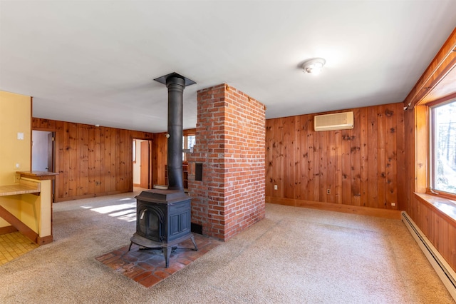unfurnished living room with wooden walls, baseboard heating, a wood stove, and an AC wall unit