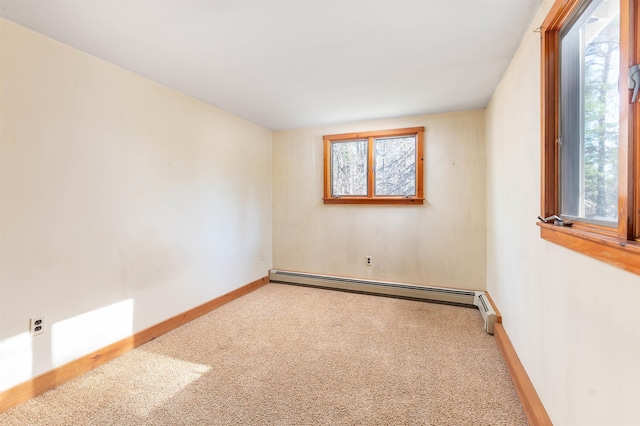 carpeted spare room featuring baseboards and baseboard heating