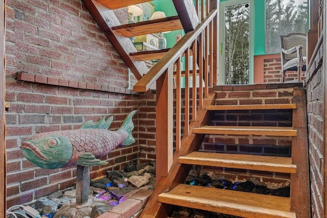stairs featuring brick wall
