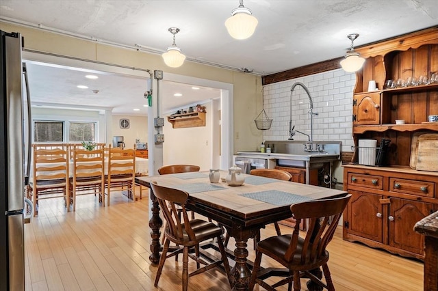 dining area featuring light wood finished floors