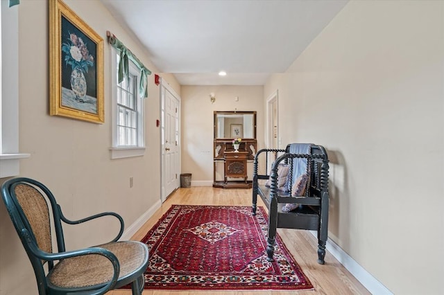 hall featuring recessed lighting, baseboards, and light wood-type flooring