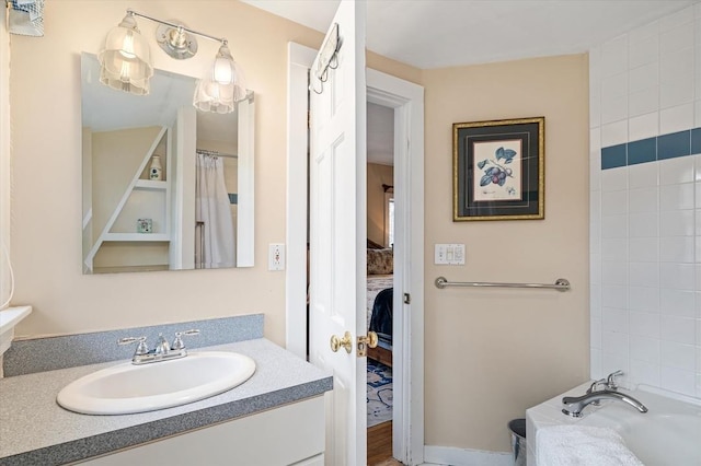 ensuite bathroom with vanity and connected bathroom