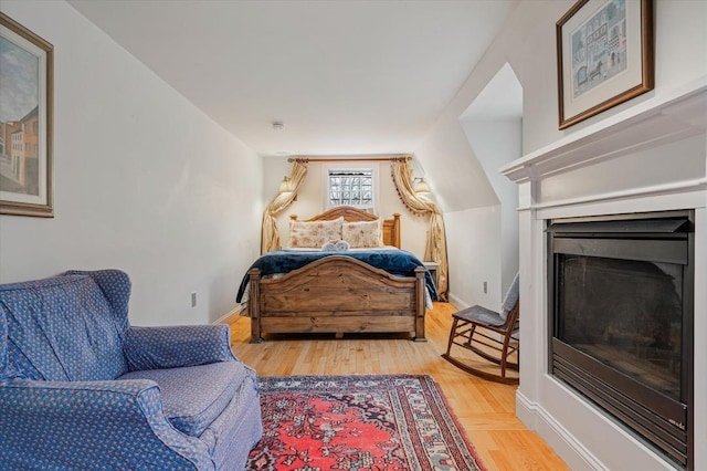 sitting room with baseboards, a fireplace, and wood finished floors